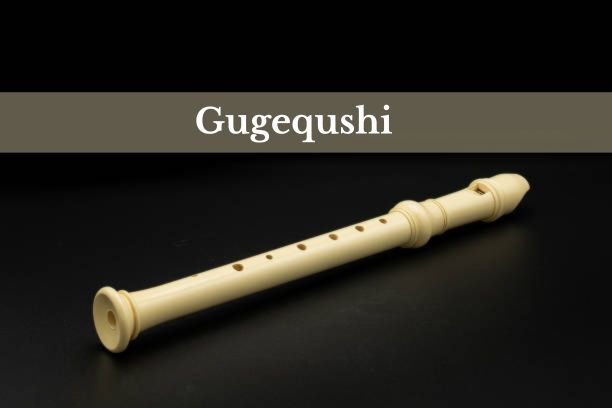 A traditional Chinese bone flute displayed on a silk cloth, symbolizing Gugequshi.
